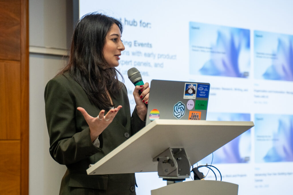 A speaker at the lectern mid-talk