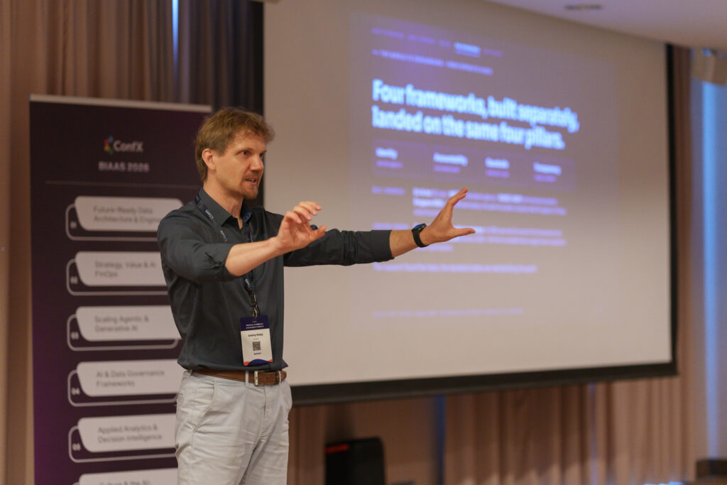 A speaker gesturing to the room